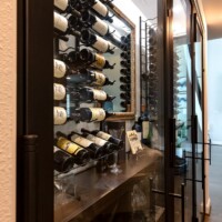 5 - Walk-in small wine cellar design with espresso-stained wooden wine racks