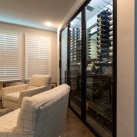 10 - A ceiling-mounted split wine cellar cooling system from CellarPro regulates the temperature inside this small wine cellar design.