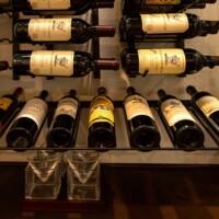 6 - Majority of the bottles in this small wine cellar design are stored in a horizontal manner.
