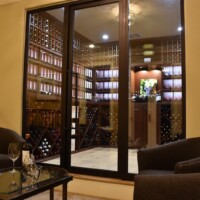 To see this residential wine cellar in Dallas upclose, you can peek or enter through this double insulated glass that has an R-value enough to prevent condensation from occurring.