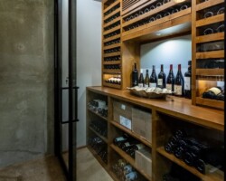 Photo of a A custom home wine closet in Dallas with traditional-industrial interiors.